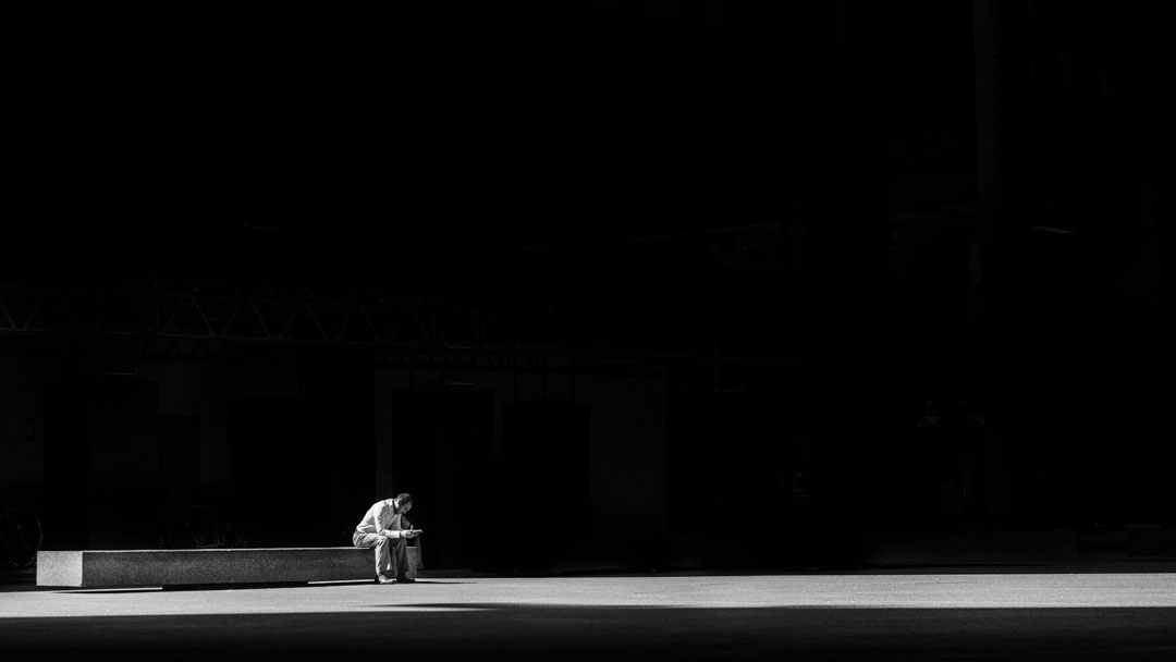 man sitting down alone