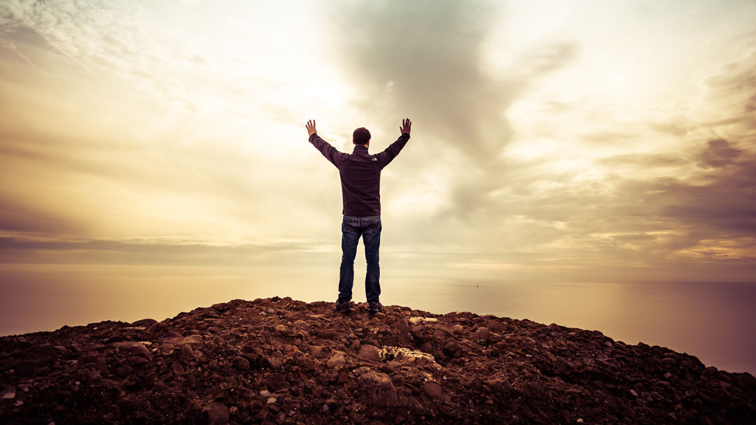 man lifting hands up