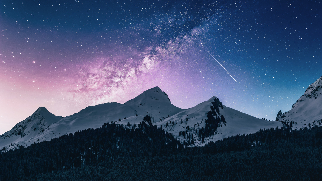 Large snowy mountains with stars above them