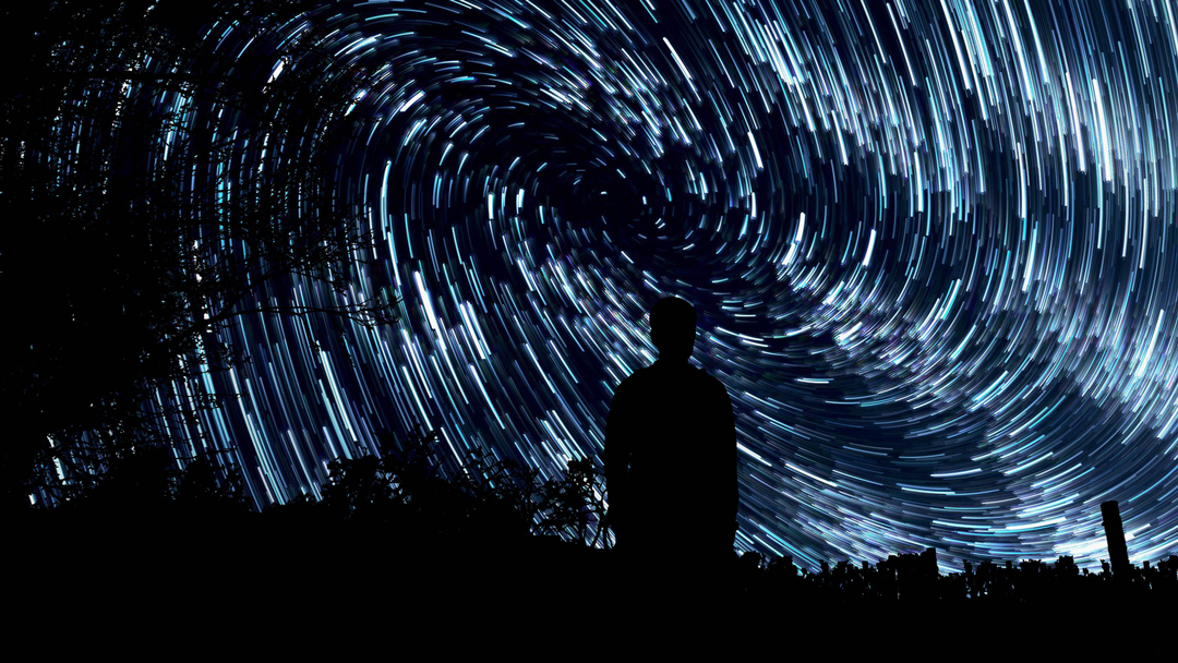 silhouette of a man and stars at night