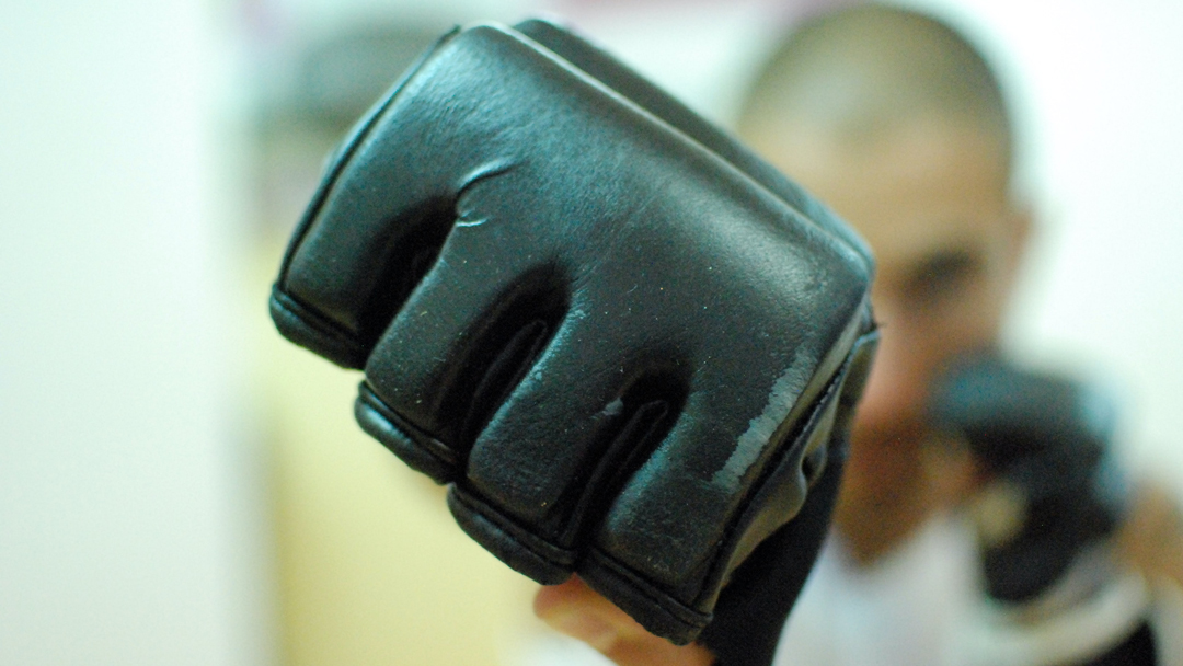 Man punching with punching gloves