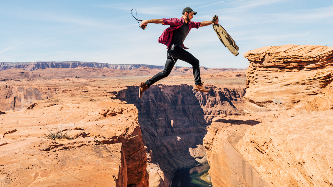 Man jumping across a canyon