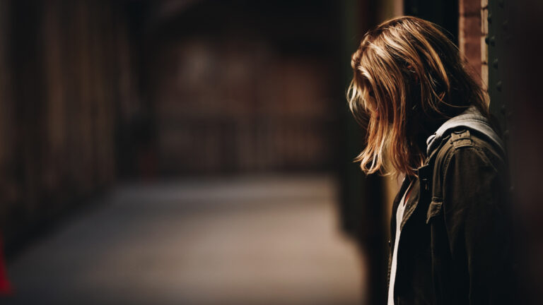 Woman with her head down looking depressed