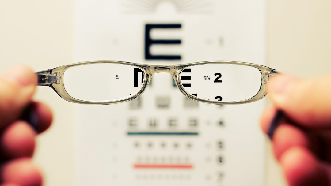 Glasses showing clear versus blurry letter chart