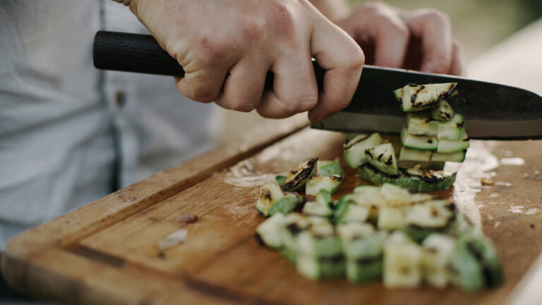 Man cutting vegetables on a cutting board