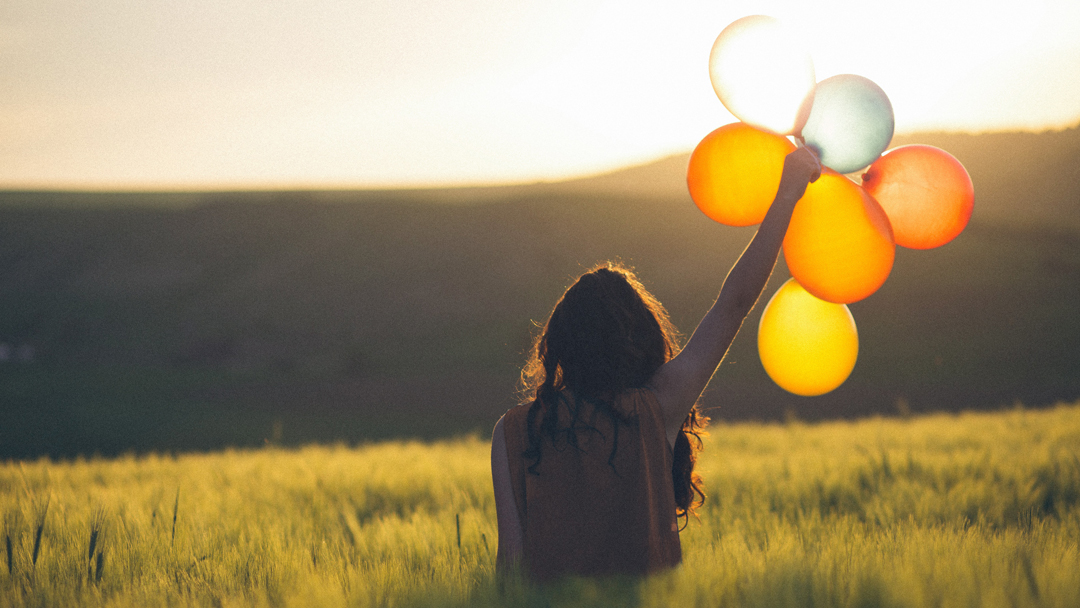 woman holding balloons