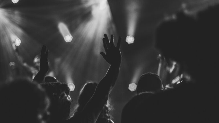 Woman holding her arms up in praise during worship