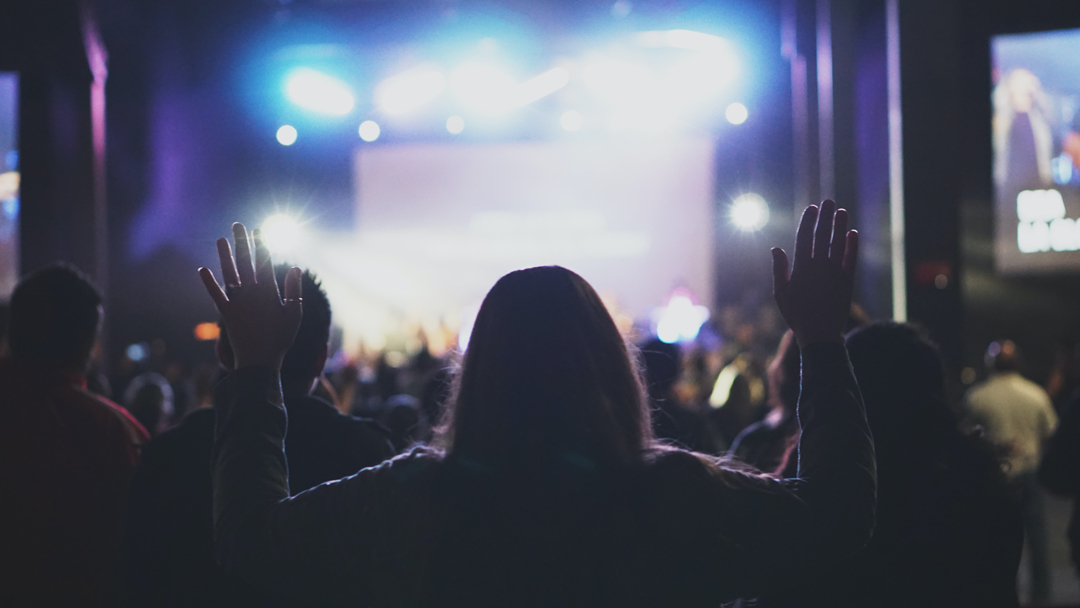 Woman holding her arms up during worship