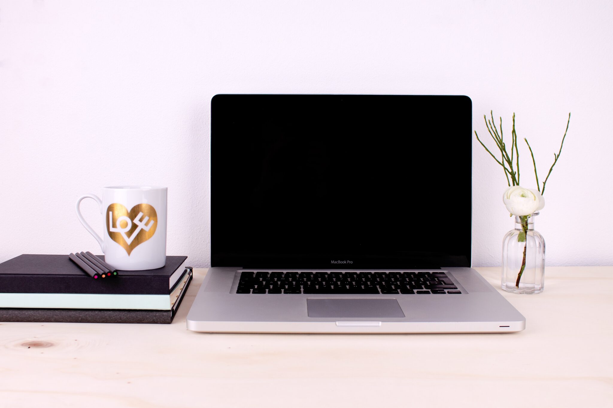 Laptop and books on a desk