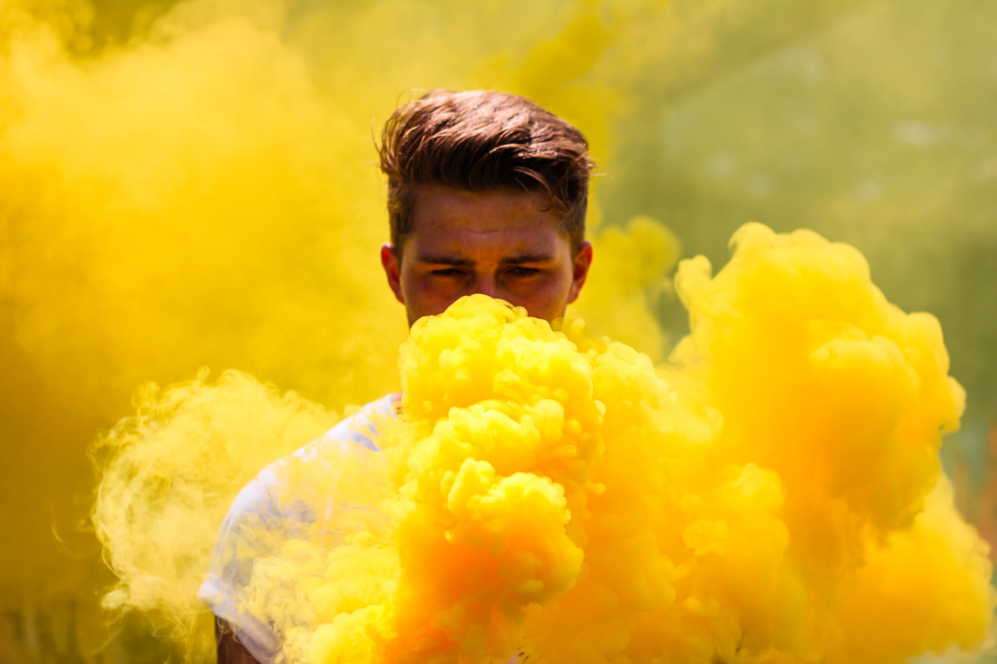 Man holding yellow smoke