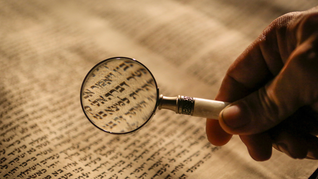 Man reading with a magnifying glass