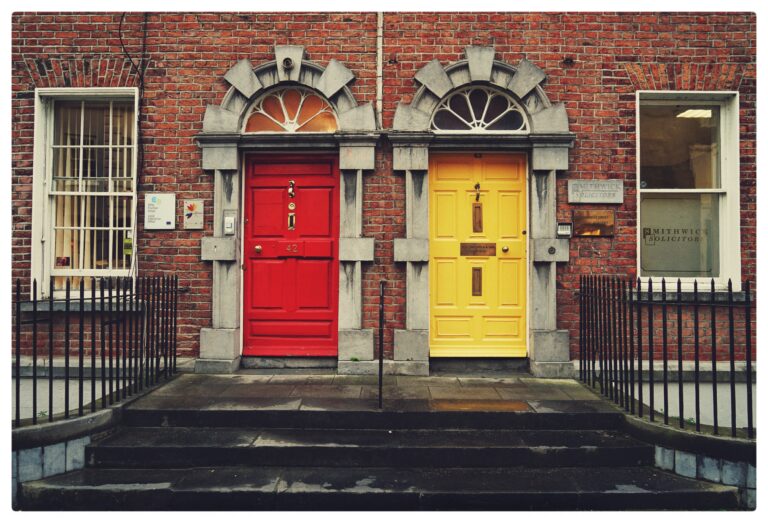 Two doors next to each other one bright red and the other bright yellow