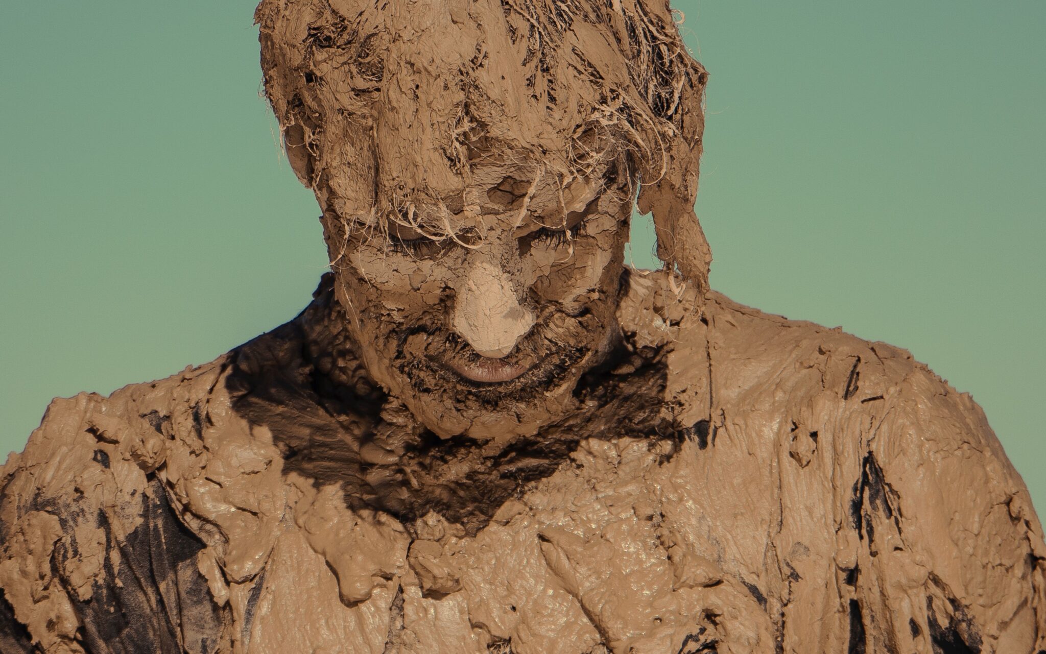 Man covered in mud