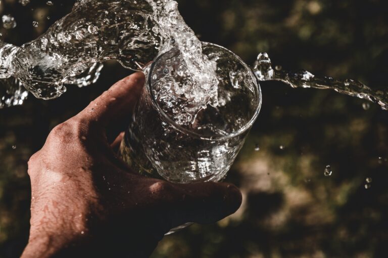 Man spilling glass of water