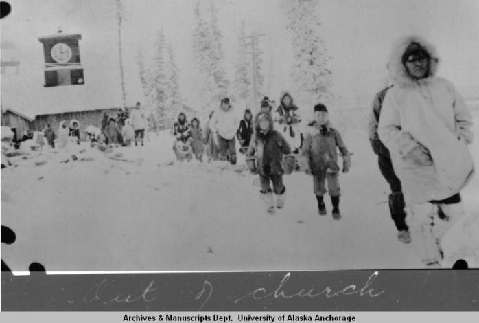 Old photo of Alaska Natives walking in the snow
