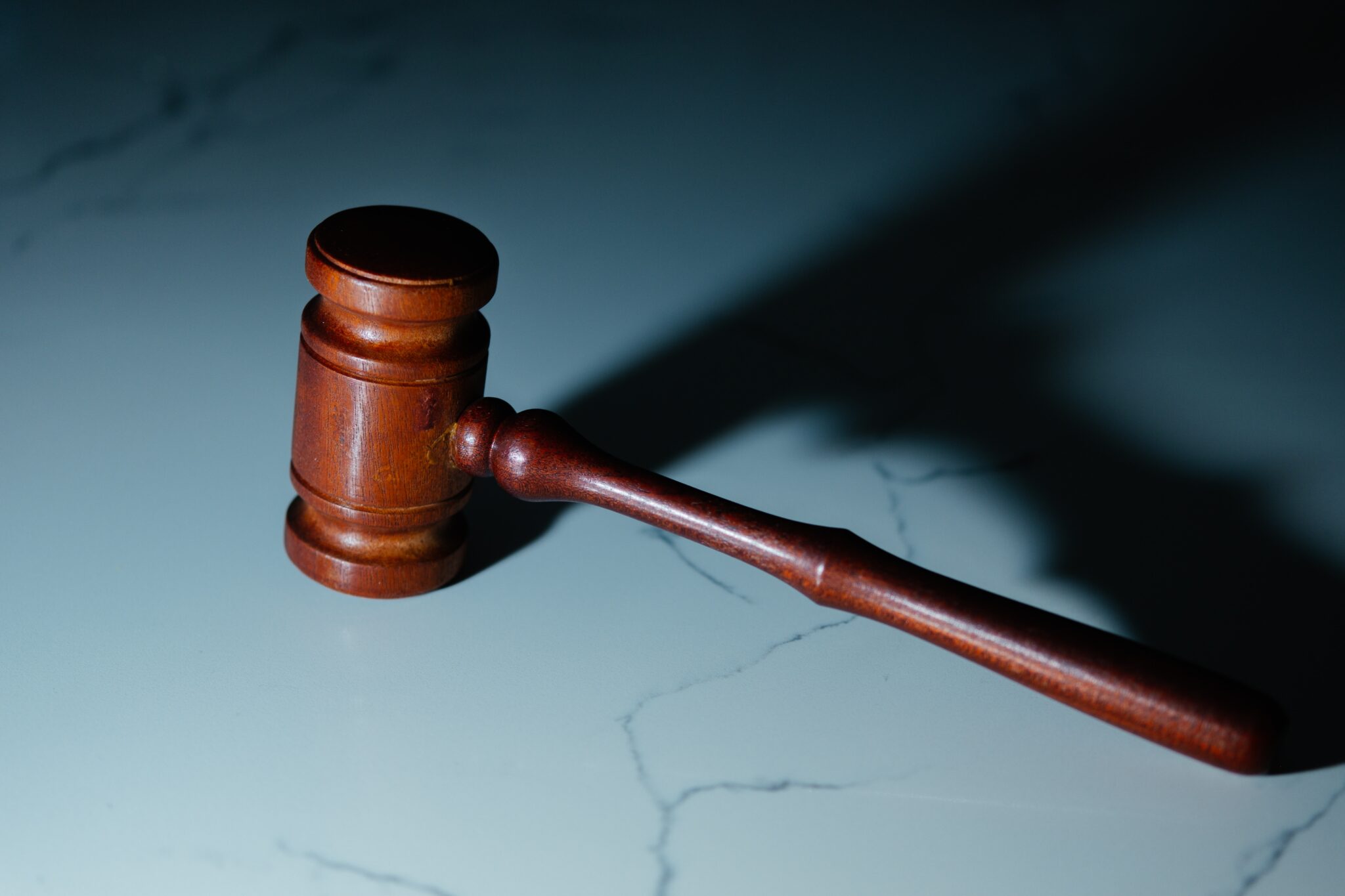 Wooden gavel on a white surface